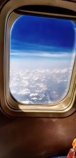 Aerial view of clouds seen through airplane window