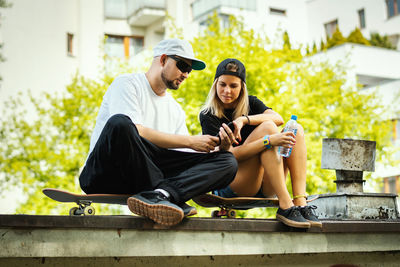 Couple sitting at skateboard park
