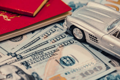 Close-up of toy car and paper currency