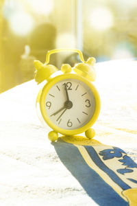 Close-up of clock on table