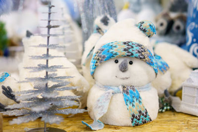 Christmas decoration toy white snowman made of cotton wool with a blue scarf, 