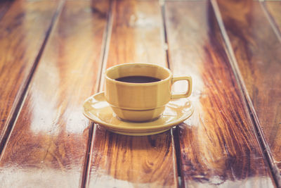 Close-up of coffee cup on wooden table