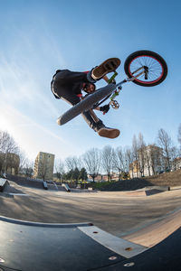 Low angle view of man skateboarding on road