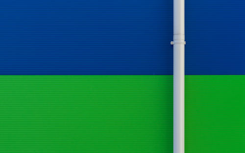 Pipe on green and blue wall