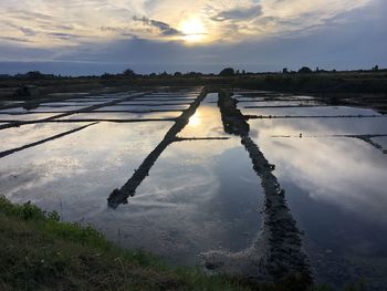 Scenic view of lake against sky during sunset