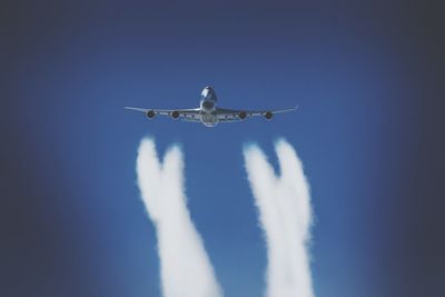 Low angle view of airplane flying in sky