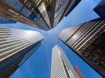 Low angle view of modern buildings in city against sky