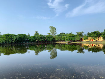 Scenic view of lake by building against sky