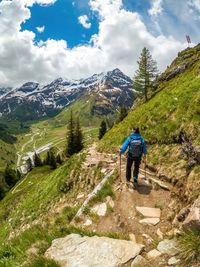 Woman hiking on footpath in the austrian alps near gastein, salzburg, austria