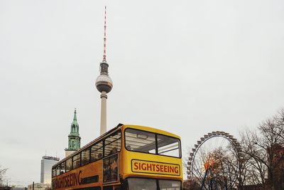 Low angle view of communications tower in city