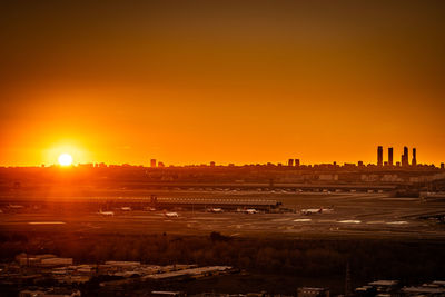 Scenic view of buildings against sky during sunset