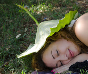 Close-up of girl lying on grass