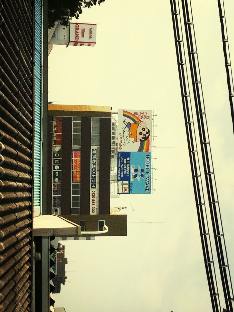 architecture, building exterior, built structure, city, low angle view, building, window, residential building, clear sky, residential structure, communication, sky, day, text, outdoors, western script, no people, city life, balcony, road sign