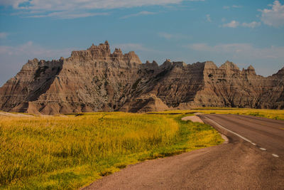 Road amidst rock formations against sky