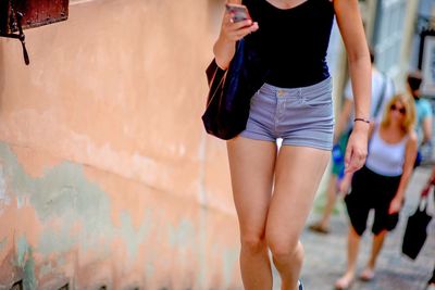 Low section of woman walking on street