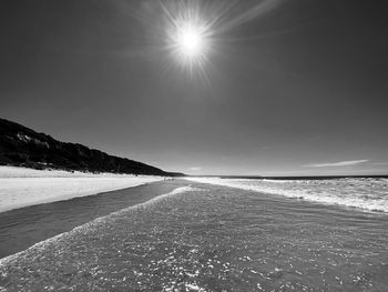 Scenic view of sea against sky on sunny day