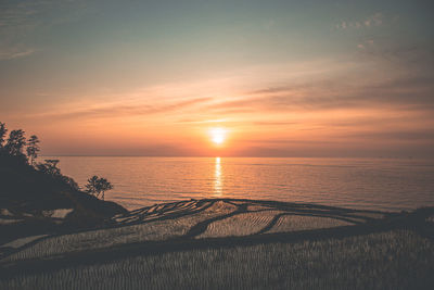 Scenic view of sea against sky during sunset