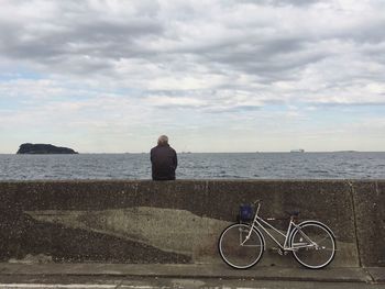 Rear view of bicycle against sea
