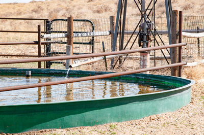 Metal railing by river in playground