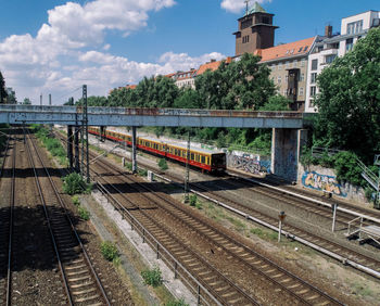 Railroad track against cloudy sky