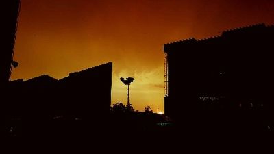 Low angle view of silhouette buildings against sky at sunset