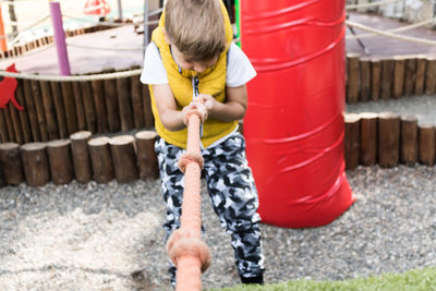 Boy playing at jungle gym