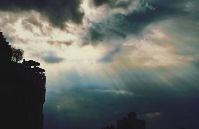 Low angle view of storm clouds over city