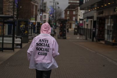 Rear view of woman walking on road