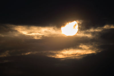 Low angle view of moon at sunset