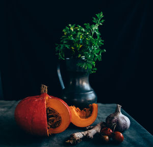 Close-up of pumpkin on table against black background