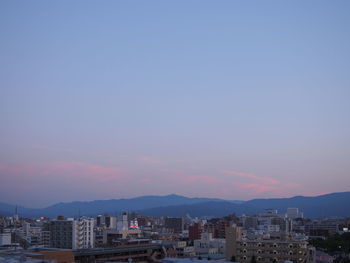 City against sky at sunset