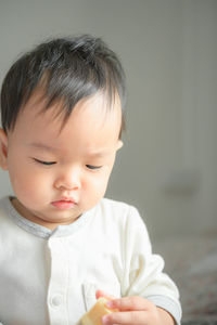 Close-up of cute boy sitting at home
