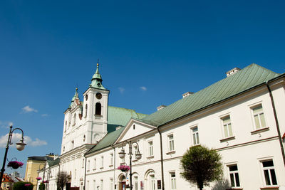 Low angle view of buildings against blue sky