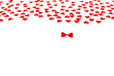 High angle view of red heart shape on white background