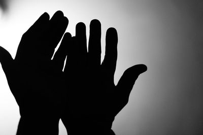 Close-up of silhouette hand against blurred background