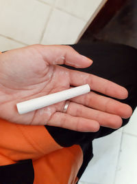Close-up of woman hand holding cigarette