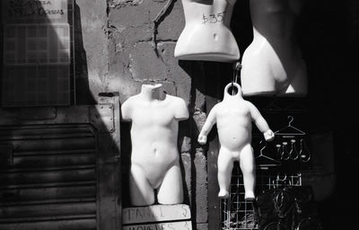 Mannequins against wall