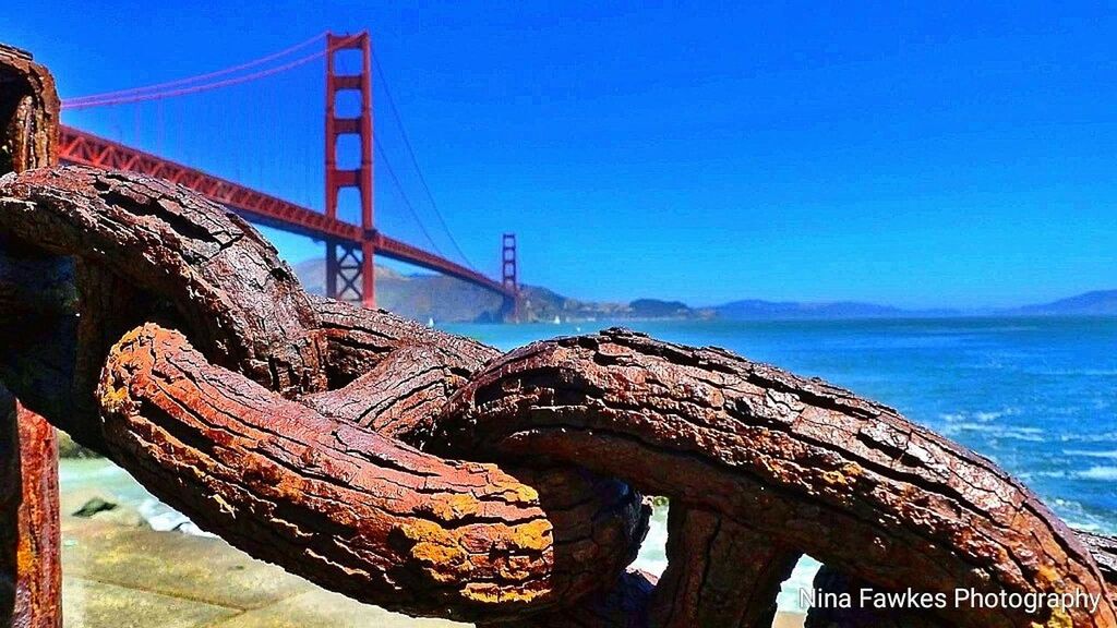 SUSPENSION BRIDGE AGAINST BLUE SKY