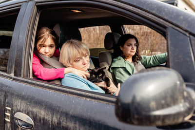 Portrait of young woman in car