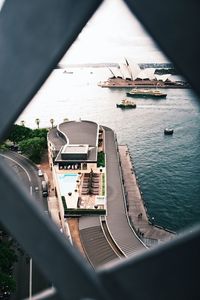 High angle view of ship amidst buildings seen through window