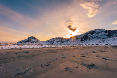 Scenic view of snowcapped mountains against sky during sunset