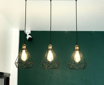 Close-up of illuminated pendant lights hanging from ceiling