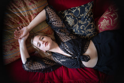 High angle portrait of sensuous woman lying on bed