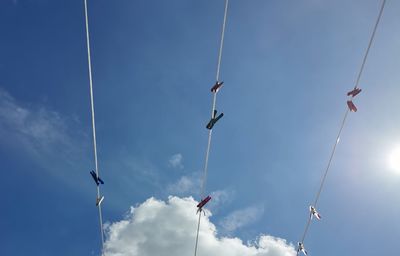 Low angle view of flags hanging against sky