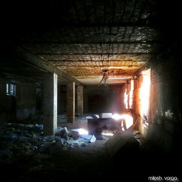 illuminated, indoors, architecture, built structure, night, abandoned, window, house, interior, lighting equipment, dark, damaged, obsolete, run-down, ceiling, building exterior, no people, deterioration, light - natural phenomenon, glass - material