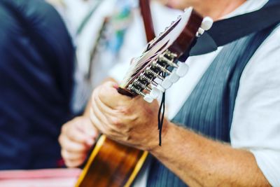 Close-up of man playing guitar