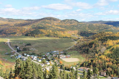 High angle view of village and mountains against sky