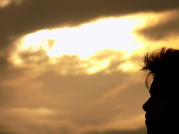 Silhouette of tree against cloudy sky