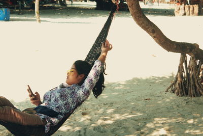 People on beach against trees