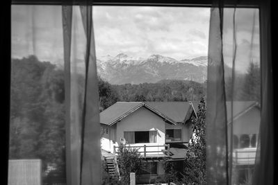 Houses against mountain range